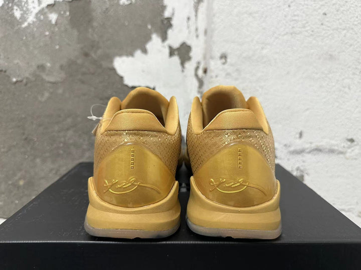 Rear view of gold Nike Kobe 5 basketball shoes