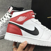 Close-up side view of the red ankle panel, winged emblem, and black side logo.
