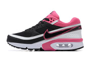 Side profile of a black, white and pink Nike Air Max BW-style sneaker.