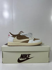 Side profile of a low-top sneaker with white overlays, a brown central panel, a cream Swoosh, and a cream midsole on a shoebox.