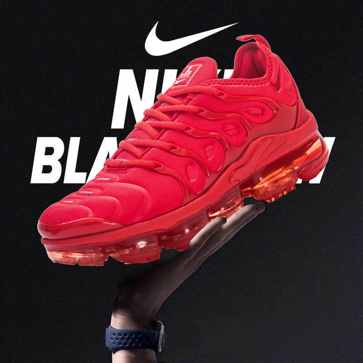 Red Nike sneaker with a translucent segmented sole, shown against a black background.