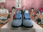 Front view showing the pair's light blue toe boxes, laces, mesh panels, and black details.