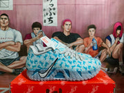 Side view of light blue Nike basketball sneakers with a patterned upper, black Swoosh branding, and translucent textured soles on a red shoebox.
