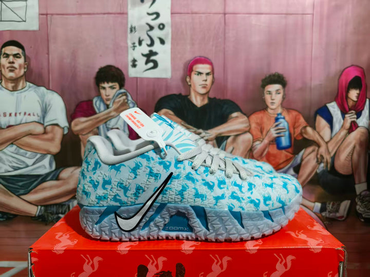 Side view of light blue Nike basketball sneakers with a patterned upper, black Swoosh branding, and translucent textured soles on a red shoebox.