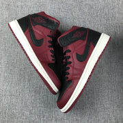 Top-down view of the pair of burgundy and black high-top sneakers.