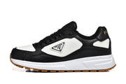 Side view of a black and white low-top sneaker with a triangular logo plaque.