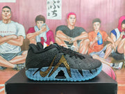 Side view of black Nike basketball sneakers with a gold swoosh detail and blue translucent-looking outsole on a box.