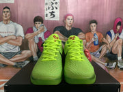 Front view of the pair showing bright lime laces, textured green toe boxes, and red tongue graphics.
