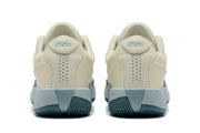 Rear view of the cream Nike G.T. Cut Academy shoes, showing padded collars and pale blue midsoles.