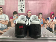 Rear view of black basketball shoes showing light-colored collar lining and red heel accents.