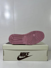 Bottom view showing the pink rubber outsole with circular traction detailing.