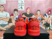 Rear view of red Nike basketball sneakers showing blue collar trim, segmented heel details, and blue outsole edges.