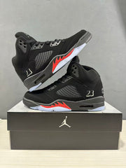 Pair of black and red Jordan Air Jordan 5 Retro high-top sneakers displayed on a black shoebox