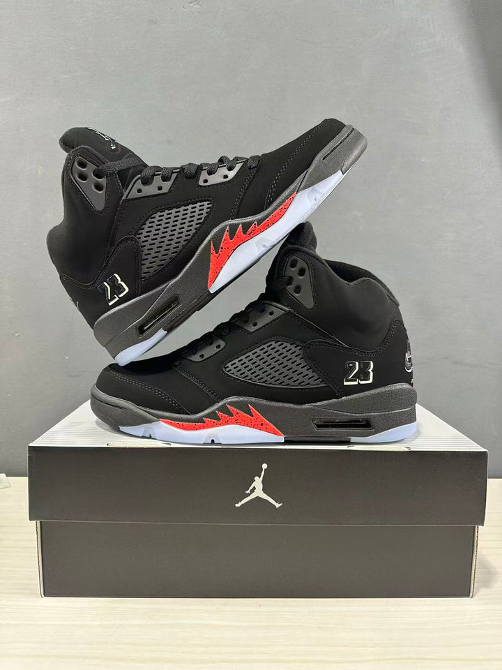 Pair of black and red Jordan Air Jordan 5 Retro high-top sneakers displayed on a black shoebox