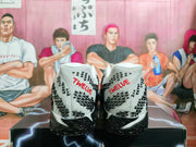 Rear view showing the white heels, black patterned details, and red TWELVE lettering.