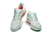 Front and top views of Nike Pegasus Premium shoes with mint laces and perforated uppers.