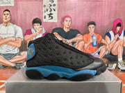Side profile highlighting the black mesh-style upper, royal blue midsole area, and black outsole.