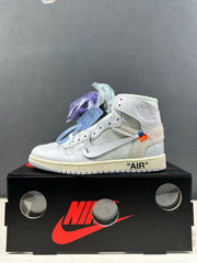 Side profile showing the white upper, beige heel overlay, blue and orange accent stitching, and printed AIR text.