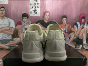 Rear view of the Nike sneakers showing the heel panels, perforated vertical details, and layered soles.