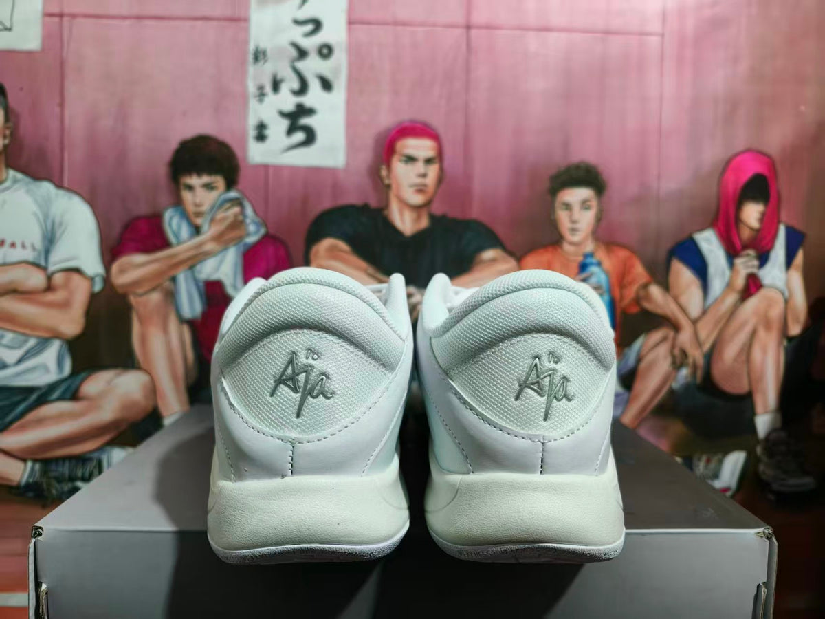 Rear view of white Nike basketball sneakers showing padded collars, heel Ja branding, and textured outsoles.