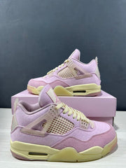 Angled side view showing the pink upper, translucent side wing, mesh panel, pale yellow midsole, and heel Air unit.