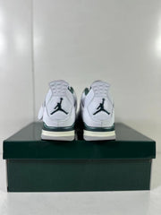 Rear view of the pair showing heel logos, green accents, and layered white midsoles.