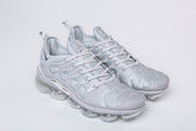 Pair of silver-gray Nike TN-4 sneakers shown from the front