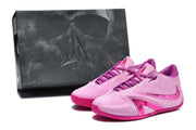 Pink basketball shoes pictured beside a dark box bearing a Freak-style logo