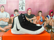 Side view of black and white high-top Nike wrestling shoes