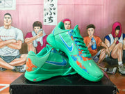 Angled view showing the mint-green shoes’ side Swoosh and colorful graphics