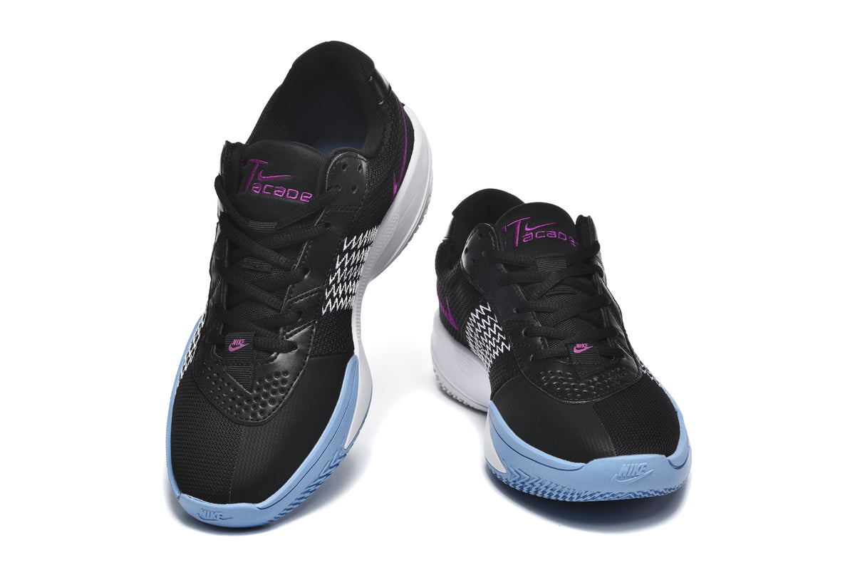Pair of black Nike basketball sneakers shown from the front, with purple branding and light blue outsole details.