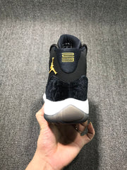 Rear close-up showing gold-colored heel branding, black textured heel panel, white midsole, and translucent outsole.