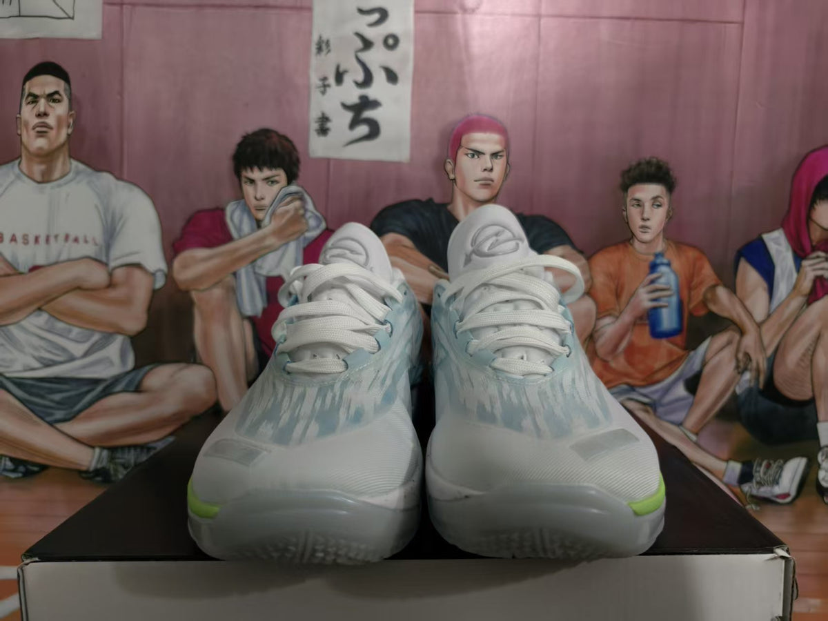 Pair of light blue and white basketball sneakers shown from the front on a shoe box.