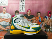Side view showing the Nike Swoosh, padded collar, perforated panels, and yellow outsole details.