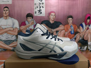 Side profile of a white ASICS Sky Elite FF shoe with navy and gray side detailing, layered panels and a sculpted sole.