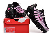 Nike Shox TL sneakers in black and pink displayed with the product box; box label shows style code IH4485-001 and a sample size.