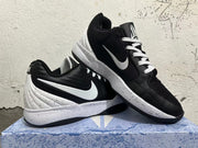 Pair of black and white basketball shoes shown from the side