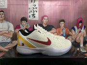 Side view of an off-white Nike Kobe basketball shoe with red side logo, gold heel detail, and number 24.