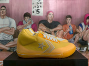Side view showing the textured yellow upper, star-and-chevron detail, white stripe, and yellow outsole.