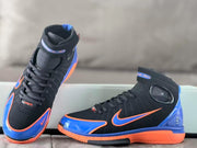 Angled view of the shoes showing the laces, collars, and side panels