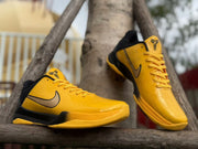 Pair of yellow and black Kobe 5 shoes, showing the side and front details.