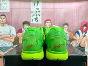 Rear view of the green sneakers showing red heel signatures, molded heel panels, and green midsoles.