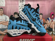 Blue and white Nike sneakers arranged on a red shoebox, showing the side panels, sculpted midsoles, and black outsoles.