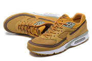 Angled top view of ochre and brown Nike Air Max BW sneakers showing mesh panels and lace-up closure.