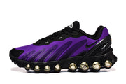 Side view of a purple and black Nike Air Max DN8 sneaker with rounded elements along the black sole.