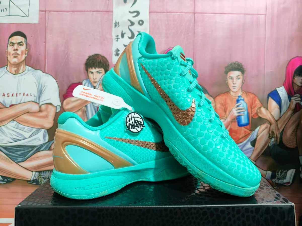 Turquoise Nike basketball shoes with bronze-colored accents shown at an angle