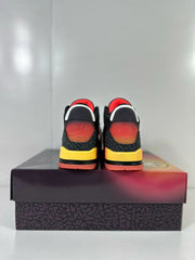 Rear view of the pair showing red-to-orange heel details, elephant-print panels, and yellow midsole sections.