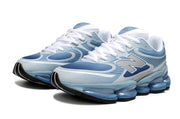 Pair of blue New Balance sneakers viewed from the front three-quarter angle.