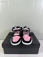 Front view of the sneaker pair showing pink perforated toe boxes, black overlays, and black and pink laces with ribbon accents.