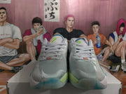 Front view of gray Jordan basketball sneakers with light green and blue outsole accents.